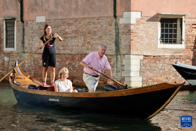 8月31日,在意大利威尼斯,“划行威尼斯”成员埃莱娜·阿尔曼西(左)为游客上课。新华社记者 李京 摄