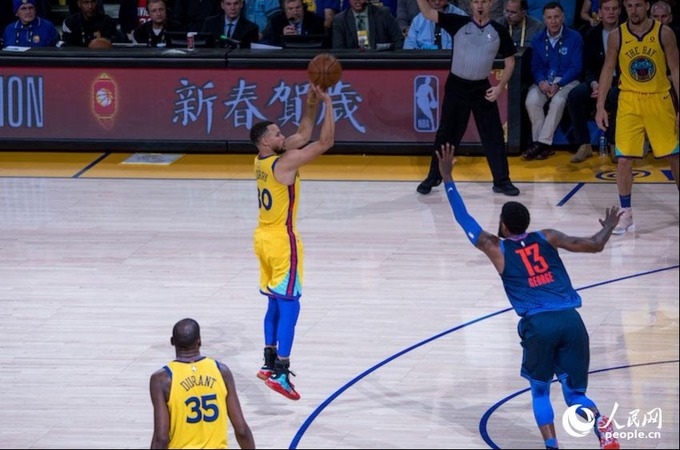 当地时间2月24日晚,2017-18赛季NBA常规赛期间,金州勇士队对阵俄克拉荷马雷霆队的赛场上点缀着中国新年元素。人民网 张洁娴 摄