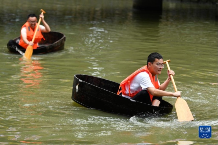 6月1日，和孚鎮(zhèn)民當(dāng)村村民參加劃菱桶比賽。和孚鎮(zhèn)鄉(xiāng)村河網(wǎng)密布，當(dāng)?shù)卮迕裼袆澚馔霸诤商林胁闪獠遏~的習(xí)俗。新華社記者 黃宗治 攝